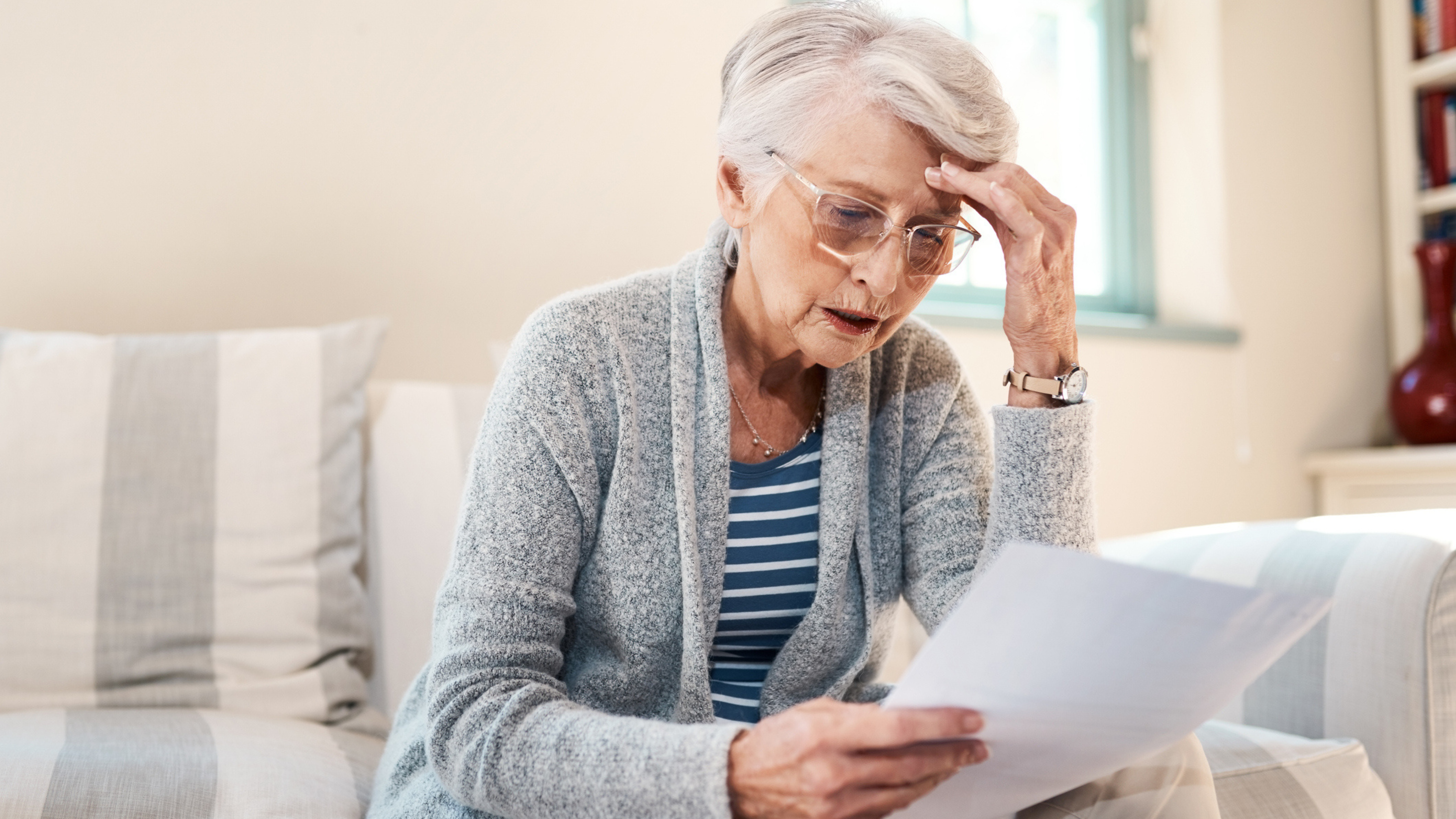 Elderly woman assessing the price of hearing aids